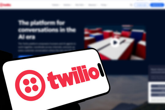 Kiel, Germany - 08-19-2026: Smartphone displaying US customer engagement software company Twilio logo in front of companys webpage