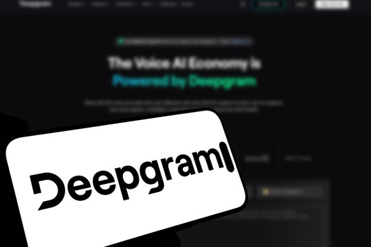 Kiel, Germany - 08-19-2026: Smartphone displaying US speech AI software company Deepgram logo in front of companys webpage