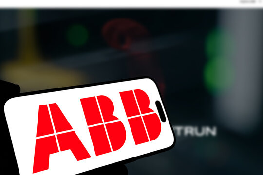 Kiel, Germany - 08-19-2026: Smartphone displaying Swiss-Swedish industrial technology company ABB Group logo in front of companys webpage