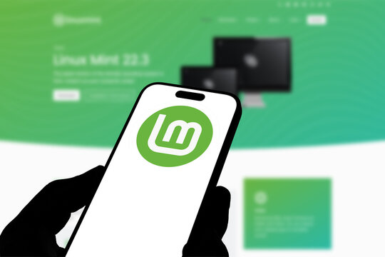 Kiel, Germany - 08-19-2026: Smartphone displaying Irish operating system project Linux Mint logo in front of companys webpage