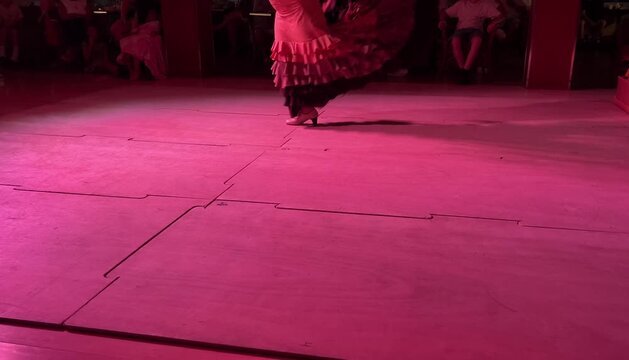 Horizontal video of women's legs dancing flamenco with swirling skirts