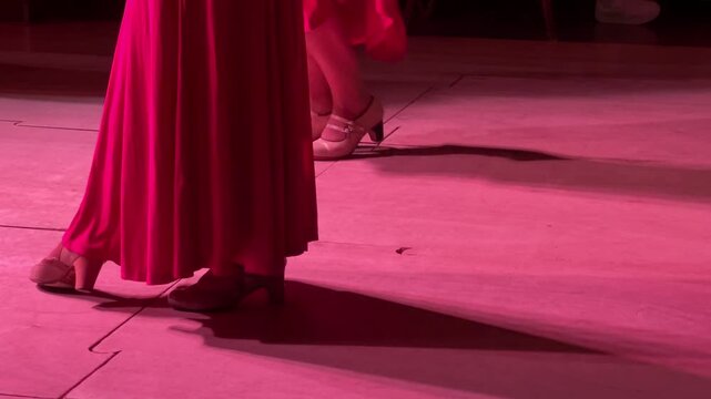Horizontal video of women's legs dancing flamenco with swirling skirts