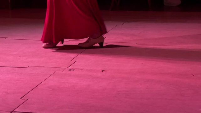 Horizontal video of women's legs dancing flamenco with swirling skirts