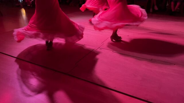 Horizontal video of women's legs dancing flamenco with swirling skirts