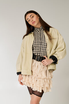 Stylish young woman radiates charm in cozy layered outfit.