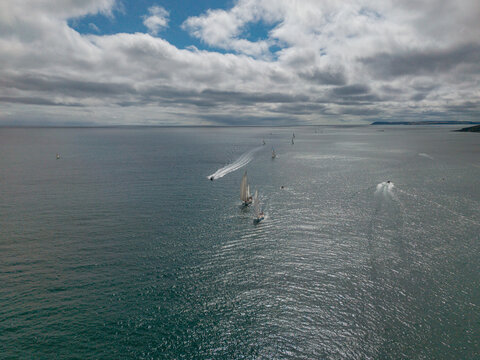 Sailboats racing in the Fowey Regatta event with clear skies and calm sea