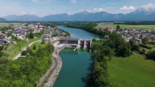 A hydropower plant is generating electricity using water and solar panels on its roof. This facility produces renewable energy.