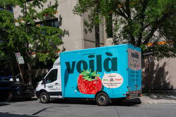 Fototapeta premium Toronto, ON, Canada - August 17, 2026: A Voila grocery delivery truck on the street in Toronto, ON, Canada. Voila is an online home grocery delivery service. 