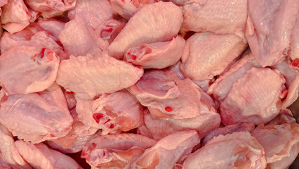 Full frame close-up texture of fresh raw chicken wings and drumettes © RilakkuMaxx