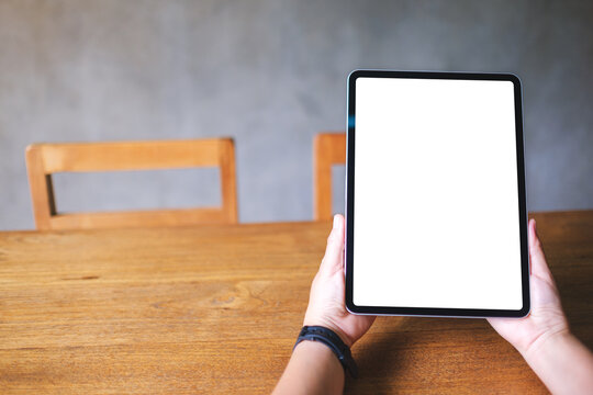 Mockup image of a woman holding digital tablet with blank white desktop screen