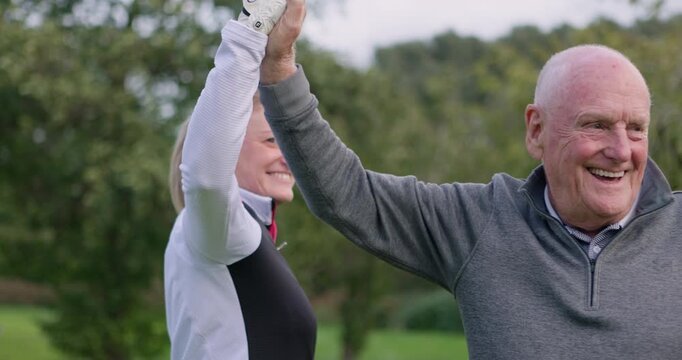 Man, woman and high five at golf course, celebration and talking with fitness, outdoor and teamwork. Elderly person, coaching and retirement with goals, workout and congratulations for achievement