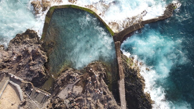 Scenic view of crystal clear ocean water in natural volcanic swimming pool at Los Gigantes, Tenerife, Spain