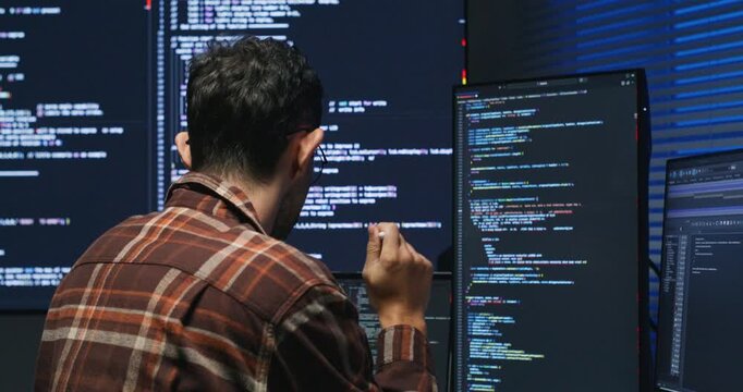 Caucasian male leads a code review, guiding junior engineers through best practices.