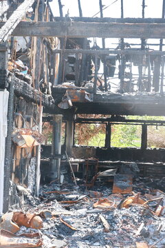 A burned down house with a lot of debris and ash