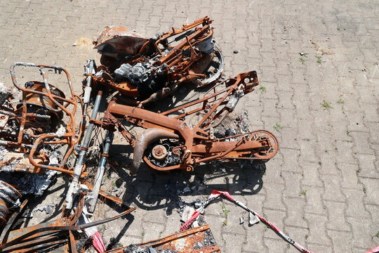 A pile of rusted and burnt motorcycle parts