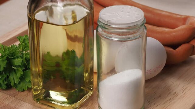 Cooking Oil Salt Parsley Eggs and Sausages in Close Up