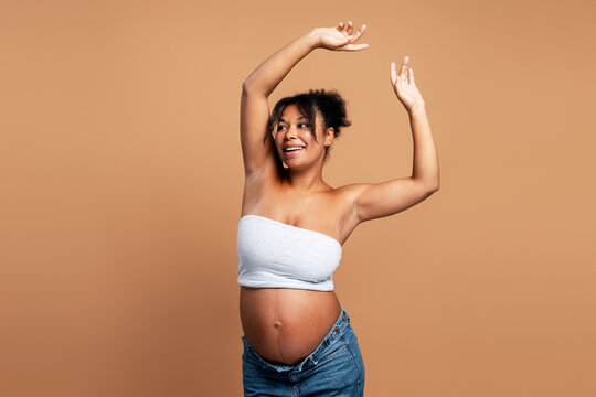 Pregnant black woman celebrating motherhood with joy