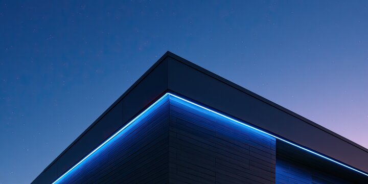 Modern building corner illuminated with vibrant blue neon lights against twilight sky