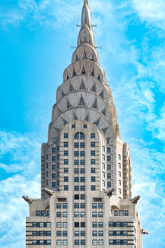 Close up detail of the iconic Chrysler Building spire highlighting Art Deco metal design and eagle gargoyles in Midtown Manhattan, New York, United States.