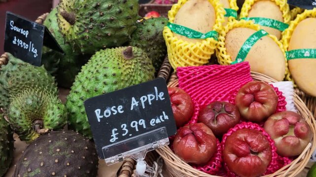 Exotic tropical fruits with price tags at a local market stall
