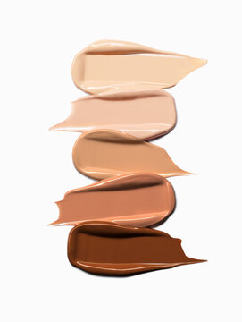 Makeup Liquid foundation smear composition isolated on white background. BB CC Cream Concealer texture. Cosmetic product brush swatch