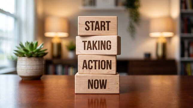 Motivational wooden blocks with Start Taking Action Now text. Inspirational business concept on office desk. Success mindset blocks.