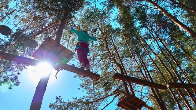 Girl climbing in adventure park