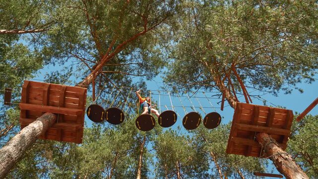 Small girl with helmet in adventure park