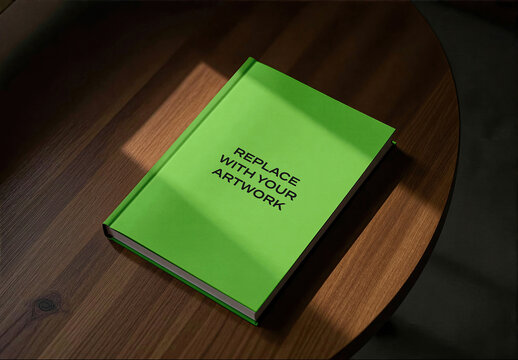 Hardcover book mockup on a wooden table in an interior studio setting with natural light, realistic cover presentation for print media and editorial design, display template