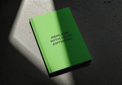 Hardcover book mockup with placeholder text displayed on a dark textured surface, angled view dramatic lighting, realistic cover presentation for print, Template, editorial or branding design