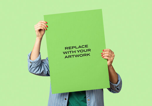 Vertical poster mockup held by hands with red nail polish against a green background, template for artwork replacement, graphic design presentation, branding display, print advertising