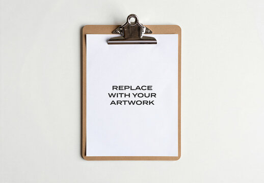 Blank paper mockup on a clipboard with leather cover and metal clip, top-down view light surface, stationery branding presentation, template for graphic design, print media, editorial layout
