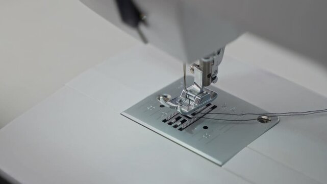Man Stitching Clothes Using an Electric Sewing Machine.