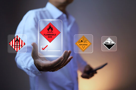 dangerous goods concept with man in white holding flammable gas warning sign represents working on hazard area