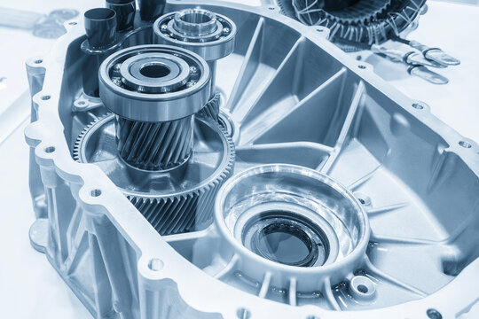 Disassembly process of automotive transmission gear parts in light blue tone lighting
