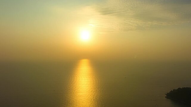 aerial hyperlapse lapse view Colorful yellow sky at sunset above freedom beach Phuket. 
Gradient color. Sky texture, abstract nature background.
Freedom beach is pure nature with out any building.