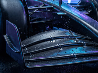 Fototapeta premium wing detail of formula one f1 racing car under rain drops close up view