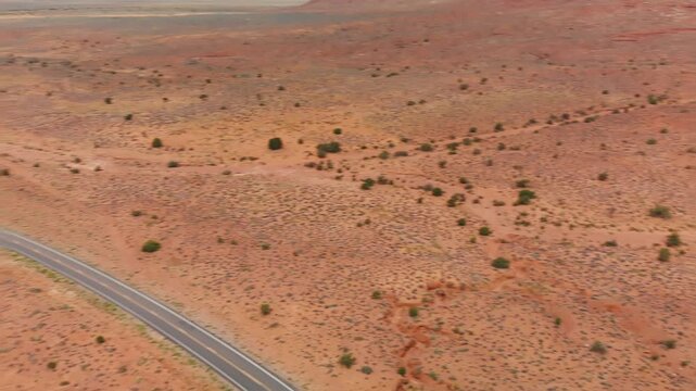 Monument Valley Mountains and road, aerial view from drone. Slow motion