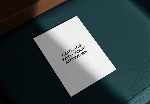 Vertical brochure mockup displayed on a dark textured surface with wooden edge, realistic print presentation under natural lighting, commercial graphic design template for branding, advertising