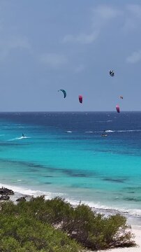 Kiteboarding Bonaire In Kralendijk Bonaire Netherlands Antilles. Thrilling Adventure With Speedboat Paragliding In Turquoise Ocean. Tropical Skyline. Summer Backgrounds. Kralendijk Bonaire.