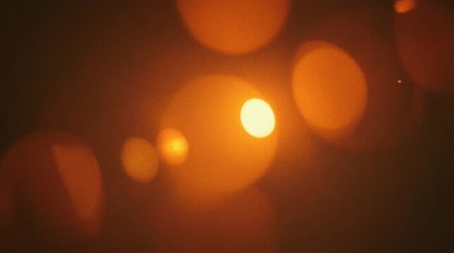 Bokeh light circles shine bright across a warm glowing dark background.