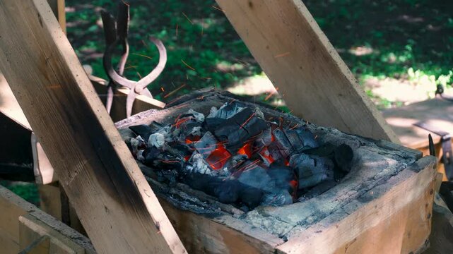 Blacksmith's bellows for heating a metal workpiece. An ancient device for forging metal.