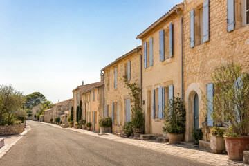 Fototapeta premium Warm stone village houses lining a peaceful sunlit street