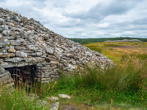 The entrance to a Neolithic burial chamber at one of the piled rock Grey Cairns of Camster, near Lybster, Caithness, in the Scottish Highlands.