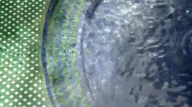 Close-up view of a traditional Zellij fountain with flowing water at Jardin Majorelle in Marrakech, Morocco, showcasing Moroccan architecture and intricate tilework.