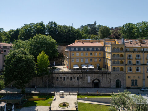 Aerial view of historic yellow building Casa da Calcada along Tamega River in Amarante