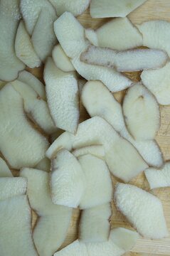 Detailed macro texture of sliced raw potato peels background