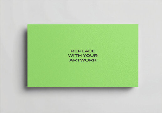 Textured business card mockup displayed on a white surface with soft shadow, flat lay stationery presentation, realistic print template for branding and corporate identity design