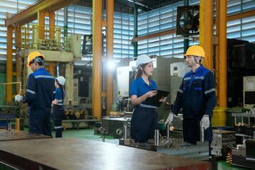 Fototapeta premium Group of male engineer worker maintenance machine in industry factory. Male technician worker working, repair machine lathe metal in the industry factory