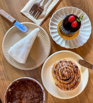Assorted Desserts and Pastries Served on a Wooden Table